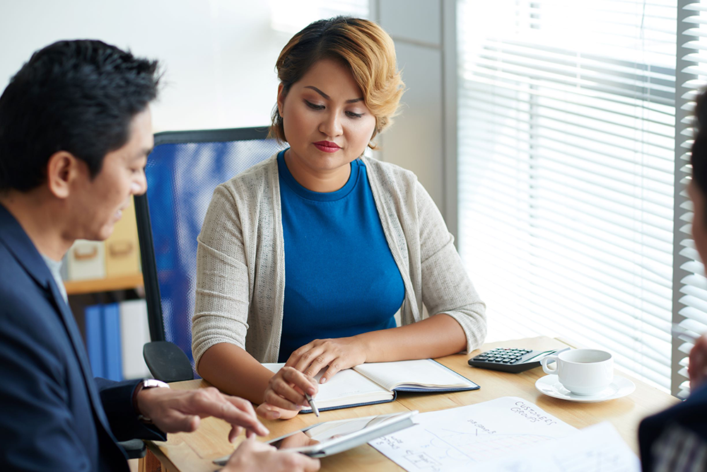 Small-business owner examining a proposal from insurance broker